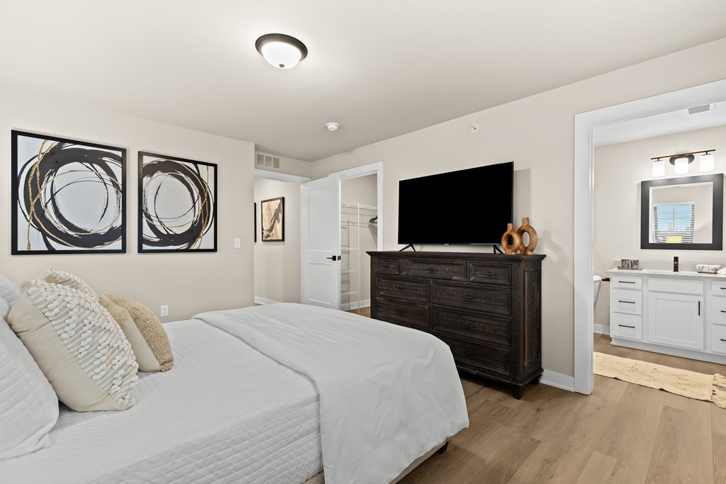 A bedroom with a large bed and a TV.