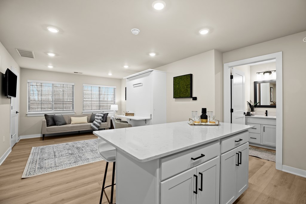 A kitchen with a white countertop and cabinets.