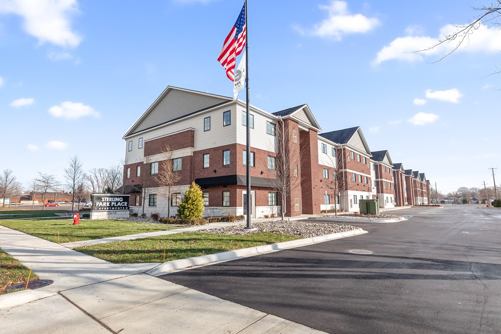 a flag pole with an flag in front of a building