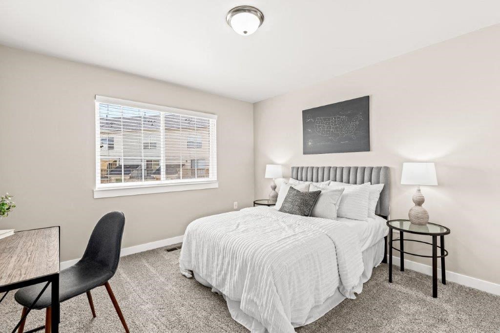 a bedroom with a bed and a window