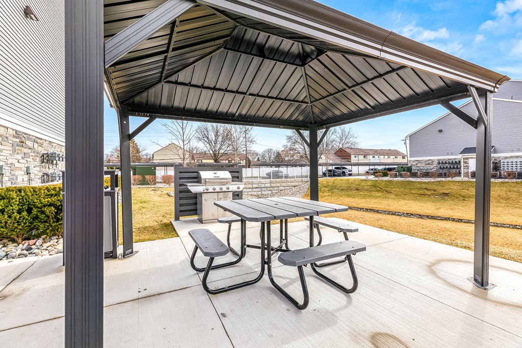 A picnic table is set up under a canopy.
