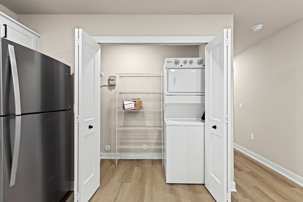 A kitchen with a black fridge and white oven.