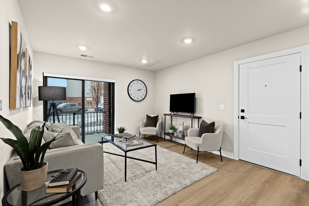 A modern living room with a glass table and a white sofa.