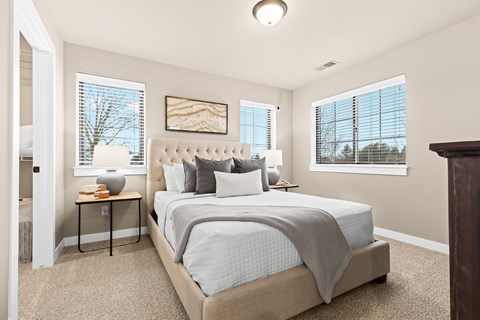 A bedroom with a large bed and a painting on the wall.