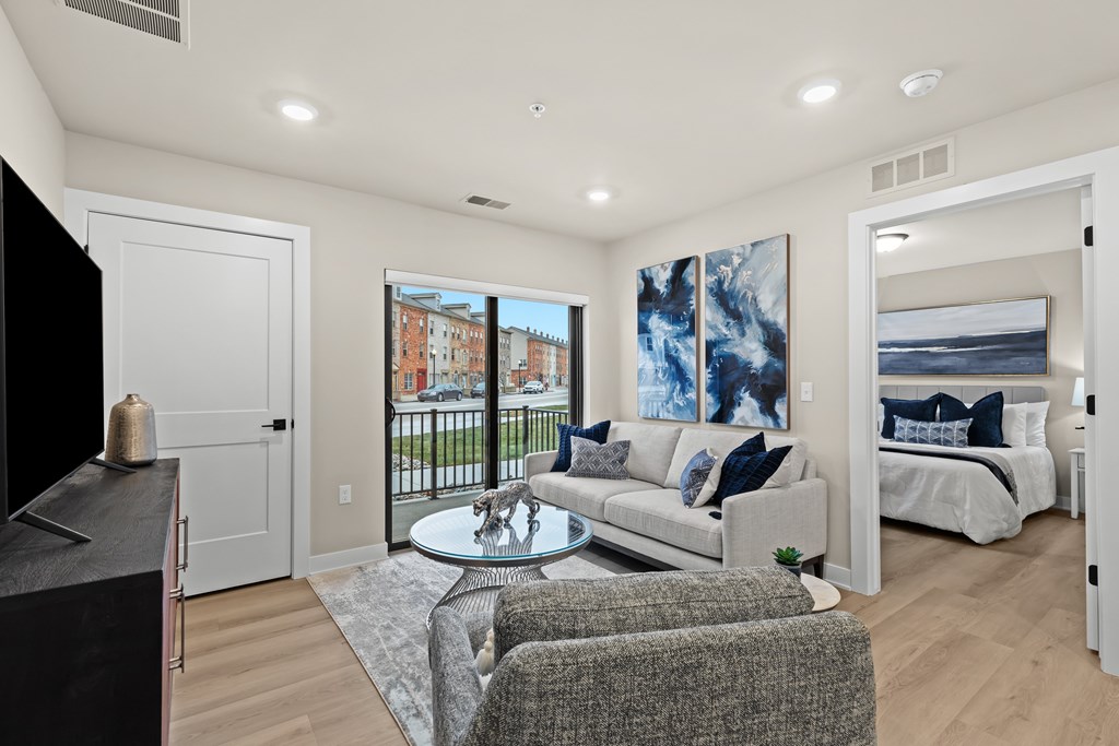A living room with a grey couch and a coffee table.