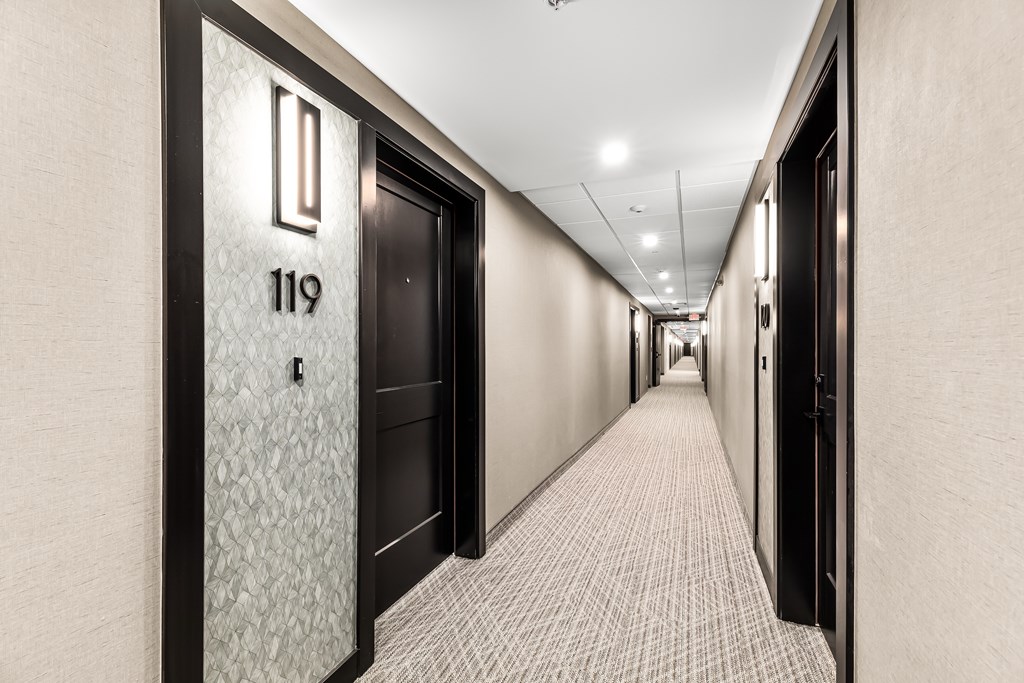 A hallway with doors numbered 119 and 118.
