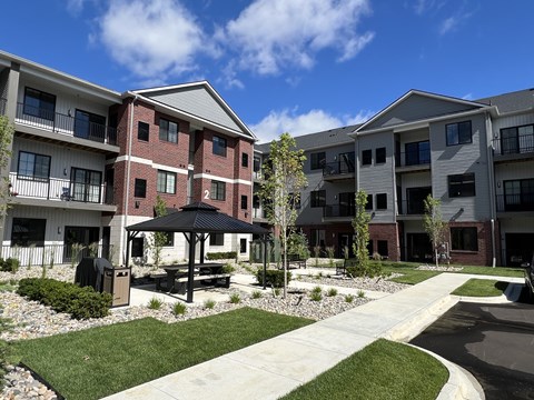 Apartment complex with a gazebo in the courtyard.