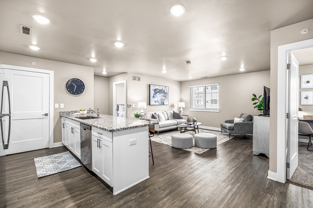 A modern kitchen with white cabinets and a large island.