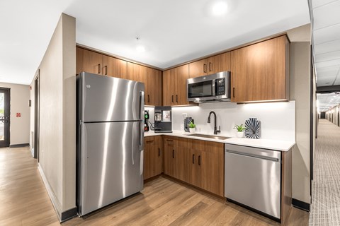 a kitchen with stainless steel appliances and wooden cabinets