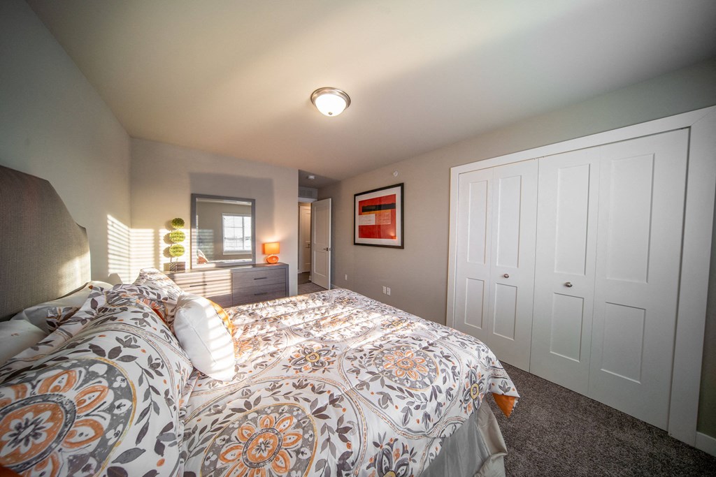 a bedroom with a large bed and a closet