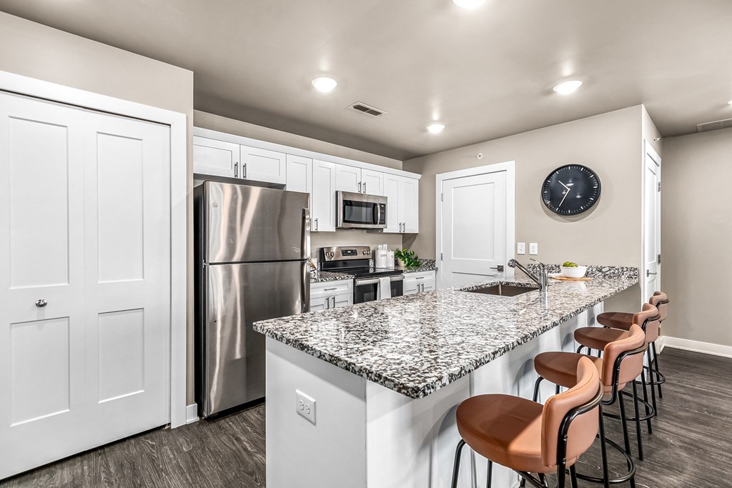 a kitchen with stainless steel appliances and a granite counter top