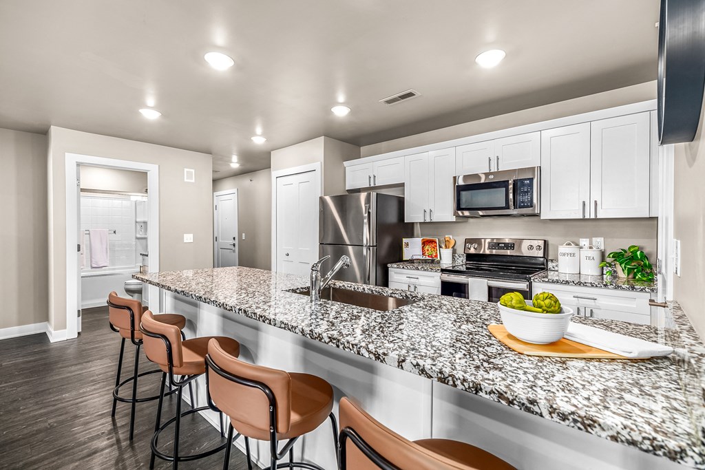 spacious kitchen with granite counter tops and stainless steel appliances
