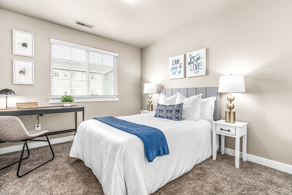 a bedroom with a bed and a desk