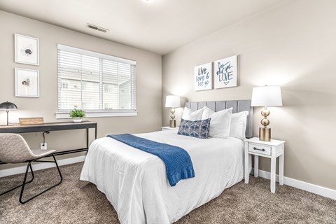 a bedroom with a bed and a desk