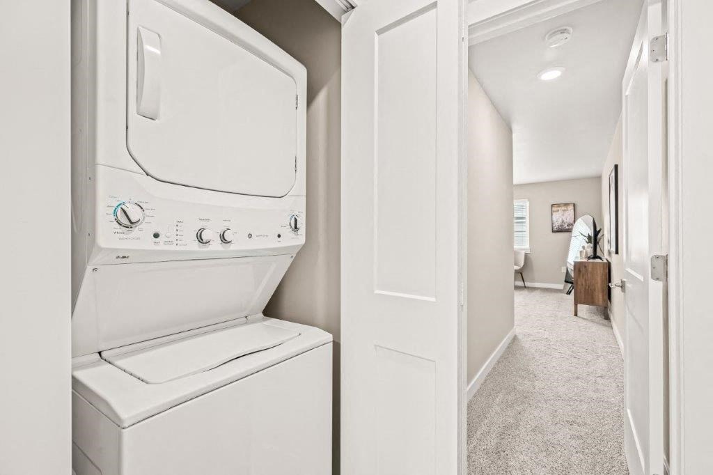 a white laundry room with a washer and dryer