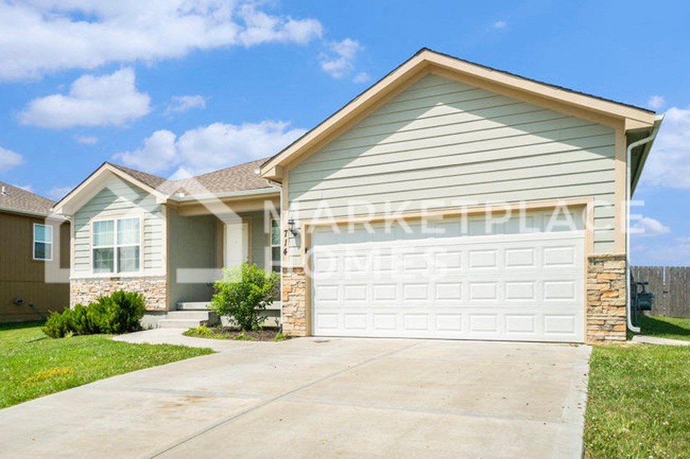 a house with a white garage door in front of it