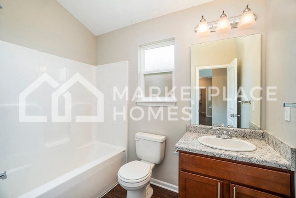 a bathroom with a toilet and a sink and a mirror