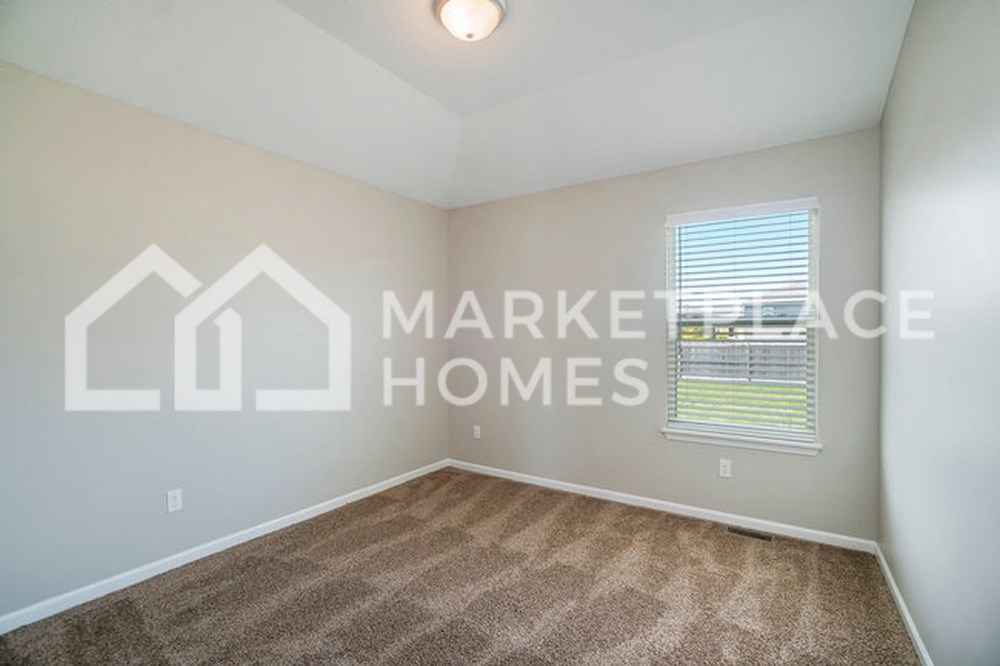 an empty room with a window and  market homes