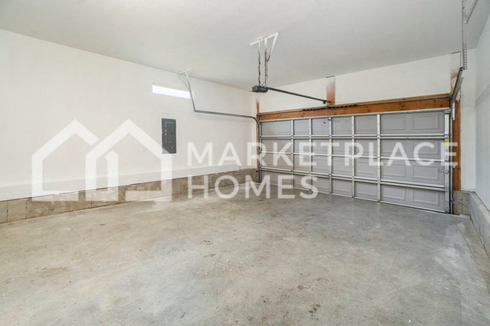 a garage with a garage door and a concrete floor