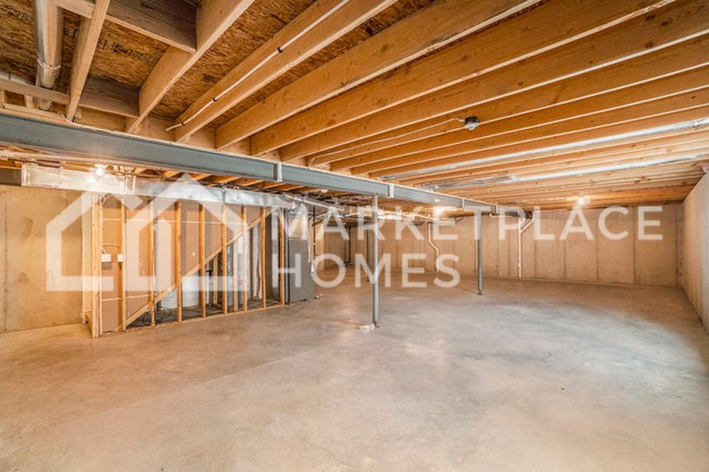 a large space with a concrete floor and wooden ceilings