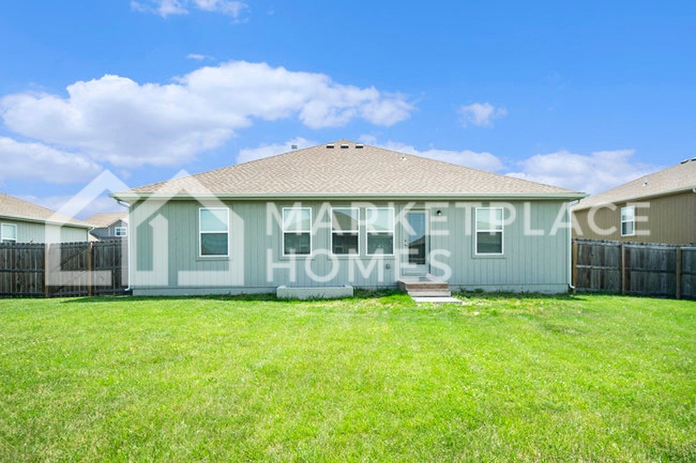 a house with a grass yard in front of it