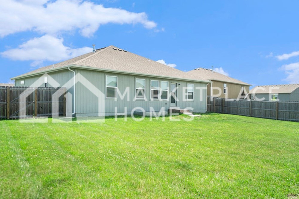 a house with a grass yard in front of it