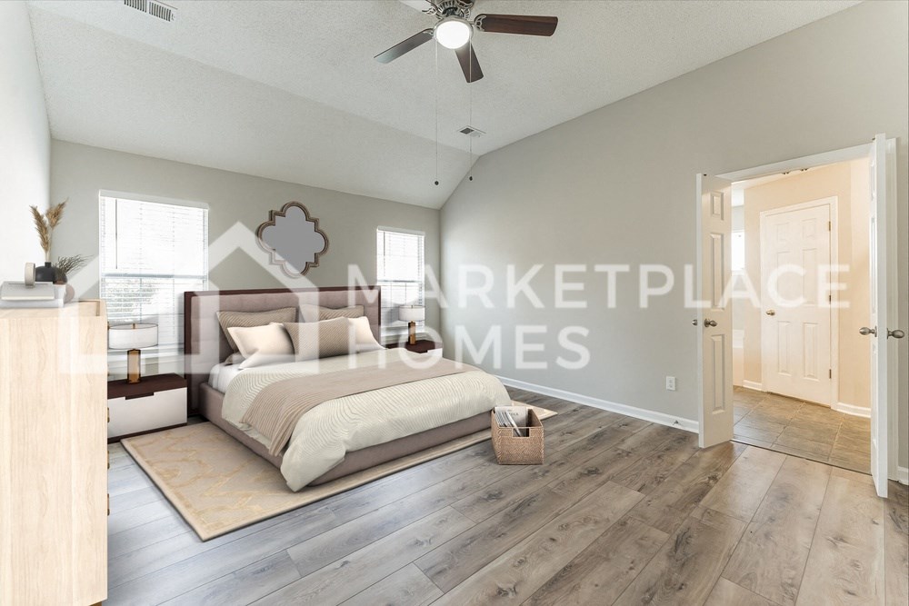a bedroom with a large bed and a ceiling fan