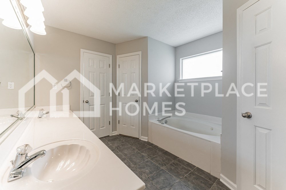 a renovated bathroom with a sink and a bath tub
