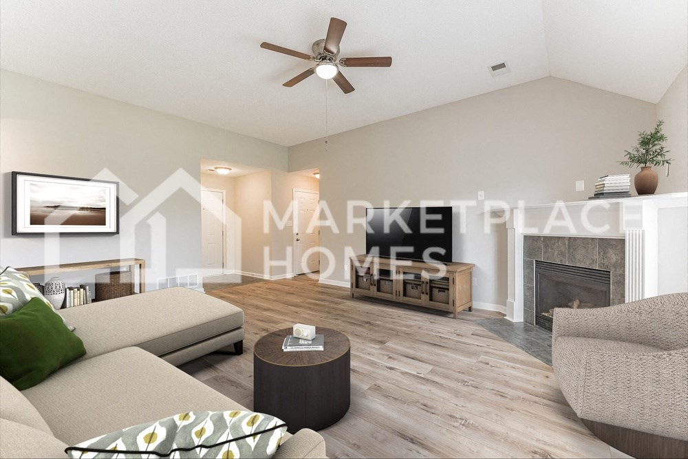 a living room with a couch and a ceiling fan