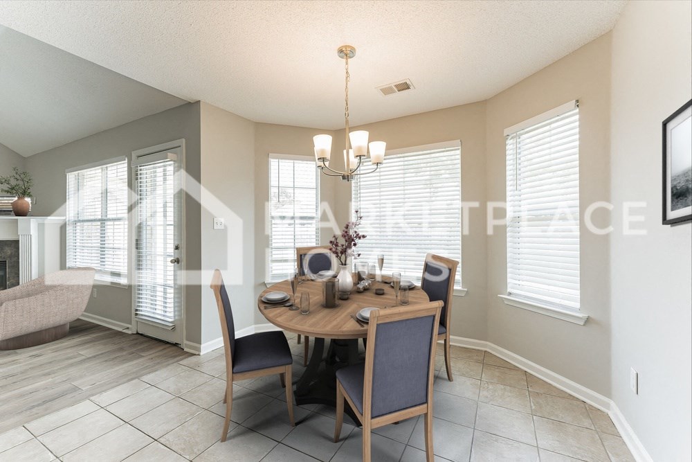 a dining room with a table and chairs and a chandelier