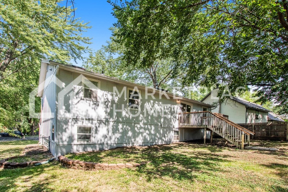the front of a house with a garage and a deck