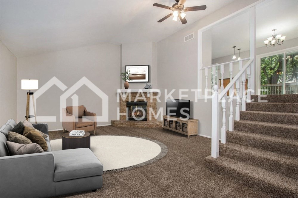 a living room with a staircase and a couch