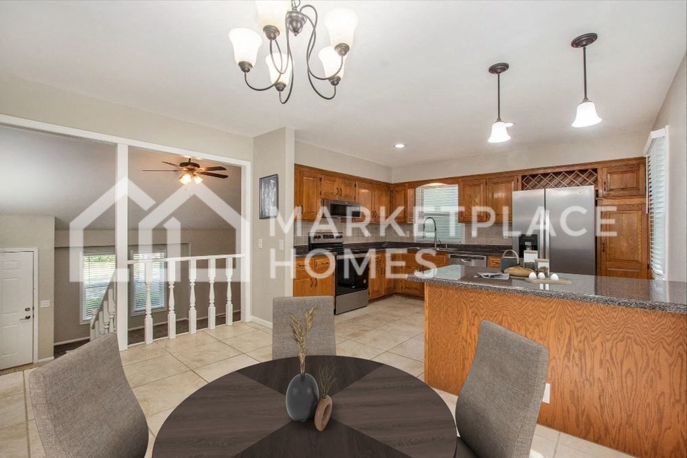 a kitchen and dining room with a table and chairs