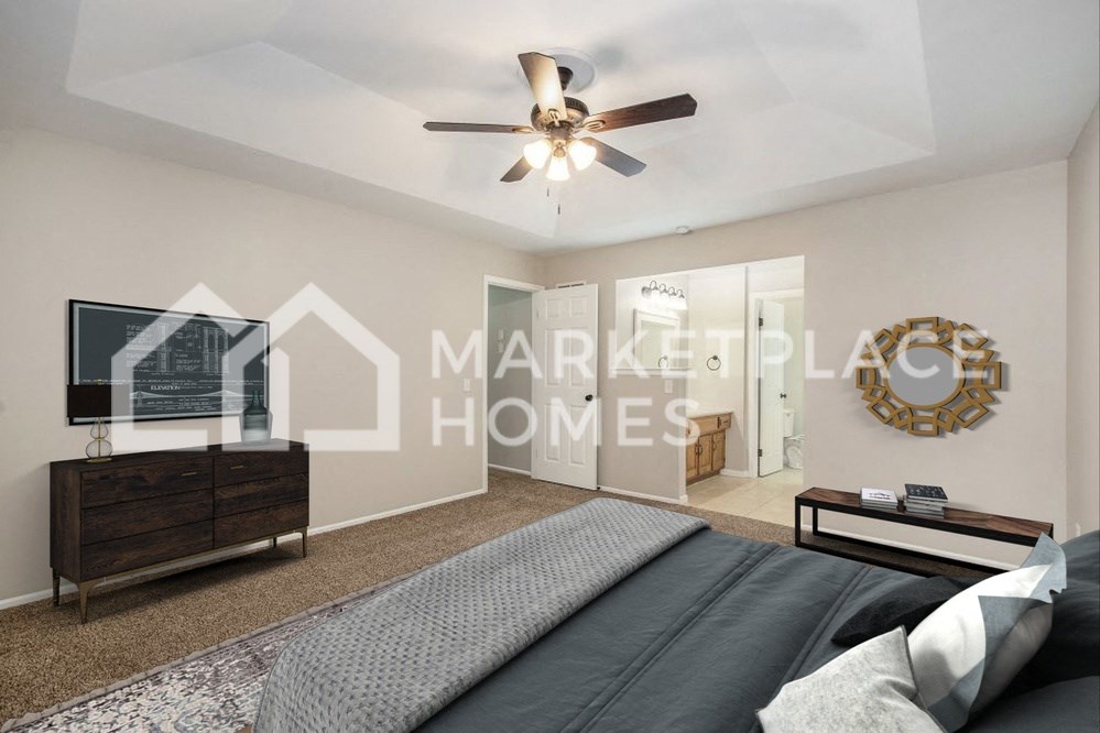 a bedroom with a large bed and a ceiling fan