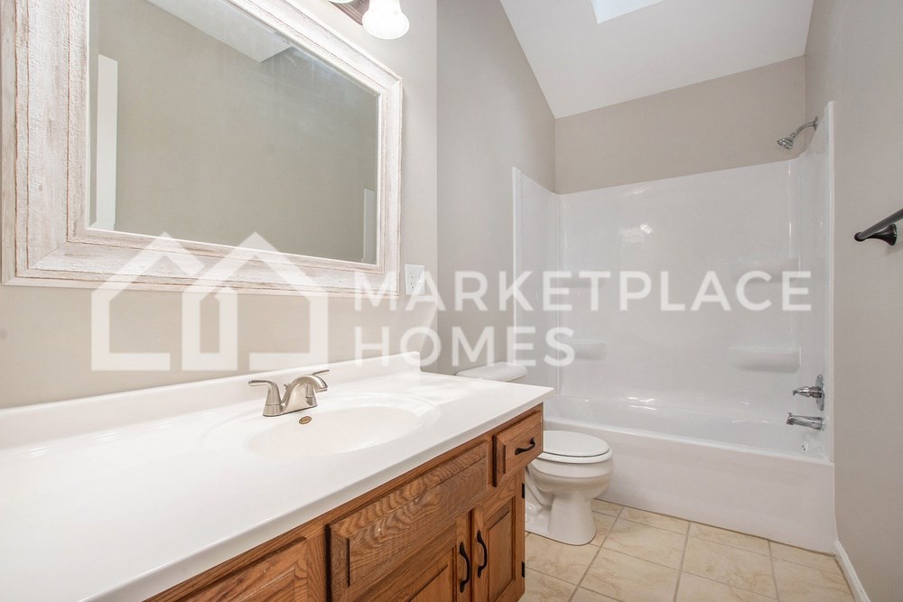 a bathroom with a white sink and a toilet and a shower