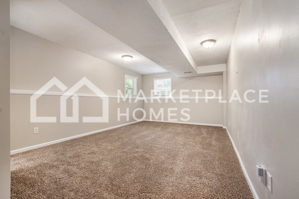 a bedroom with a carpeted floor and a large white closet
