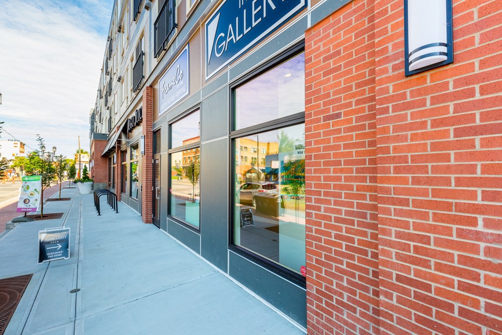 A brick building with a sign that says "GALLERY" on it.