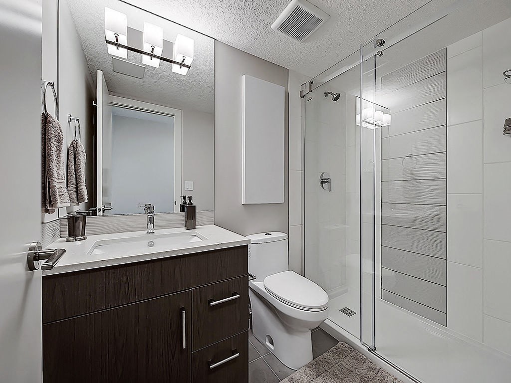 A bathroom with a white toilet and a white sink.