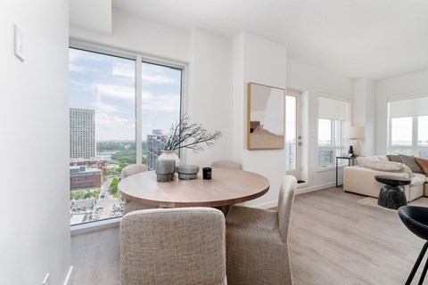 A modern living room with a round table and chairs.