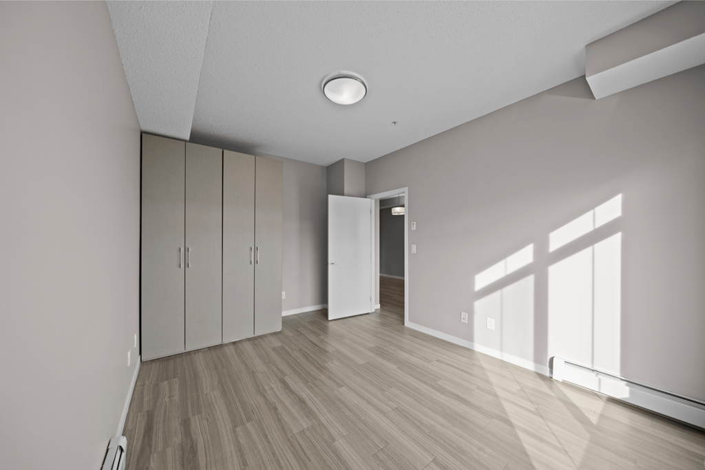 an empty living room with white walls and wood flooring