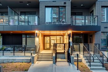 A modern building with a glass entrance and a balcony.