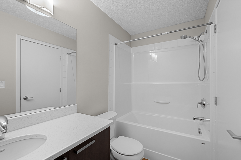 a bathroom with a shower and a sink and a toilet