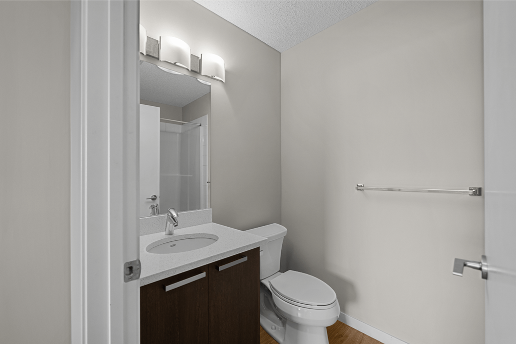 an empty bathroom with a toilet sink and mirror