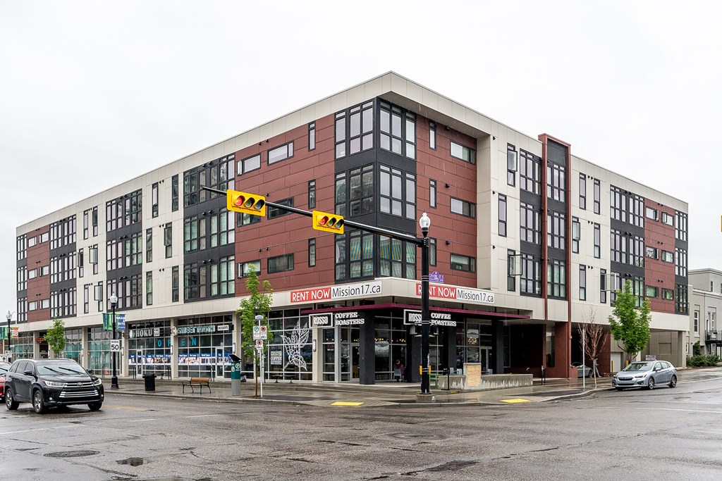 a building on the corner of a street with cars