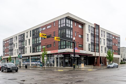 a building on the corner of a street with cars