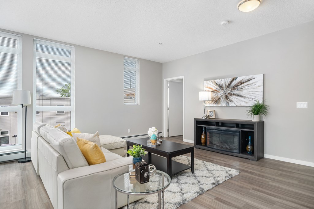 a living room with a couch and a coffee table and a fireplace
