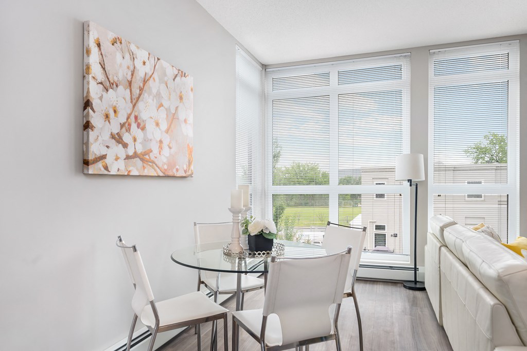 an apartment living room with a glass table and chairs and a couch