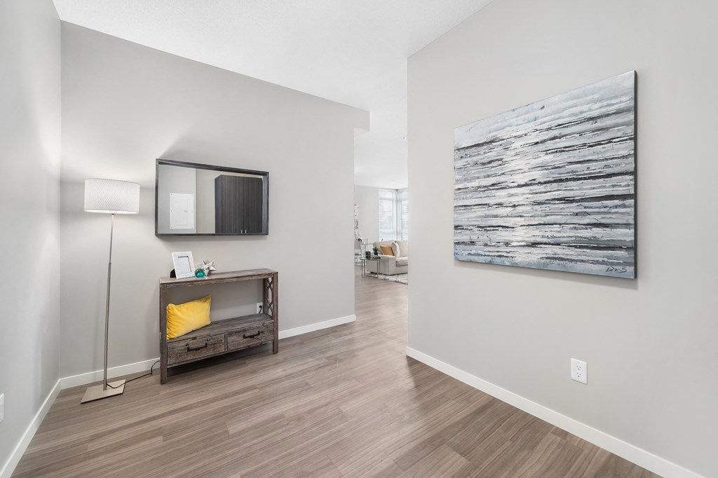 a living room with a wall mounted tv and a fireplace