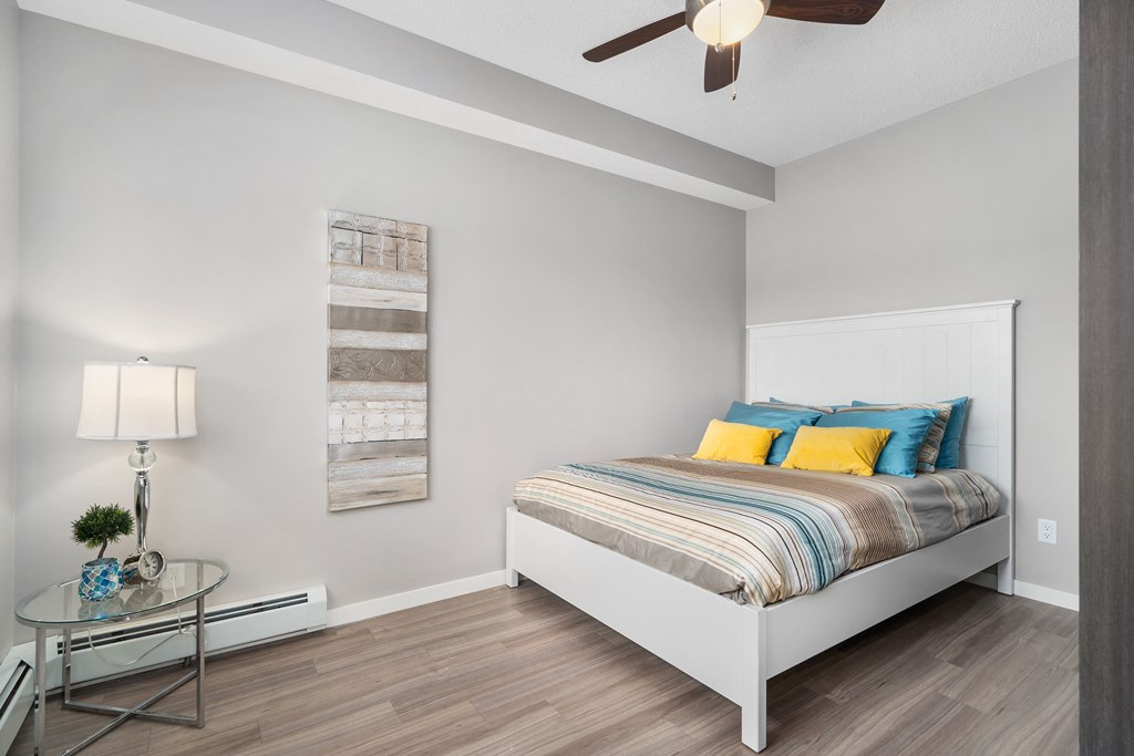 a bedroom with a bed and a ceiling fan