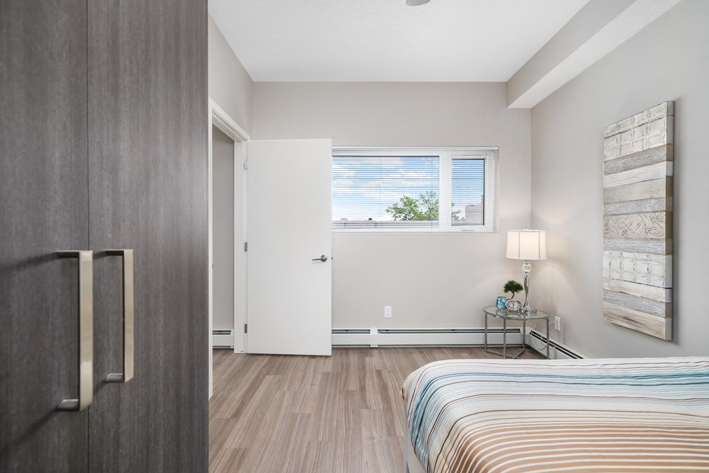 a bedroom with a bed and a door to a bathroom